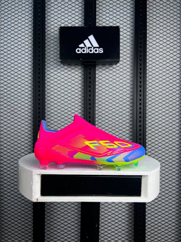 Neon pink and blue laceless football boots