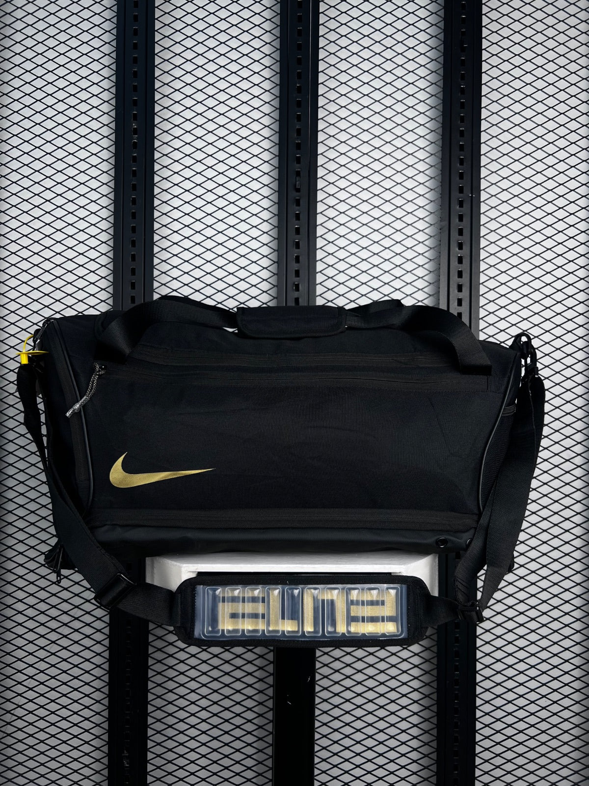 Black woven training duffel with metallic gold accent