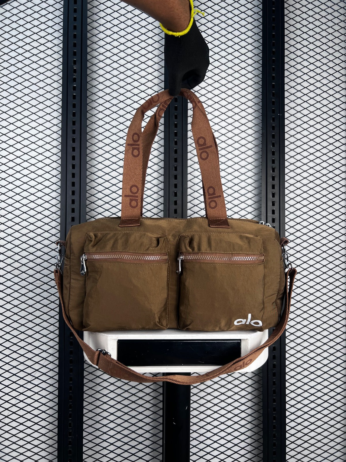 Olive nylon duffle bag with dual front zip pockets