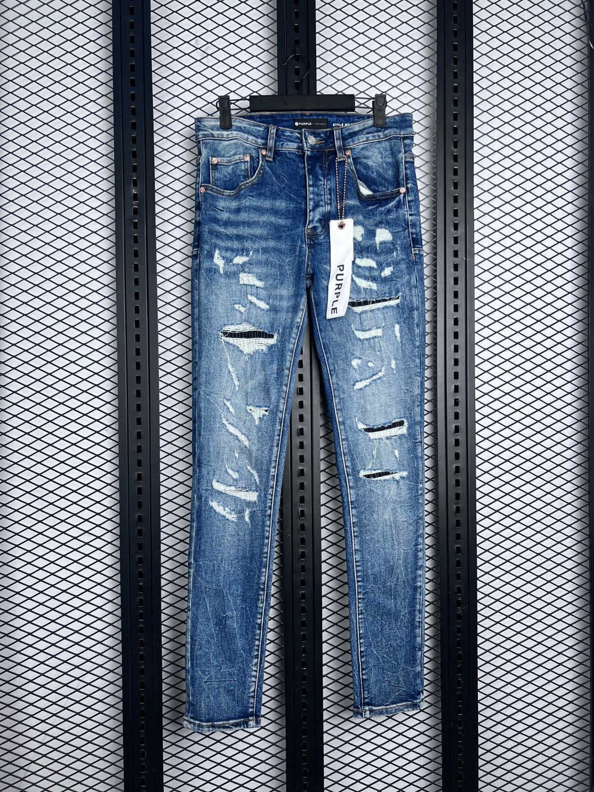 Distressed and ripped slim denim in washed blue