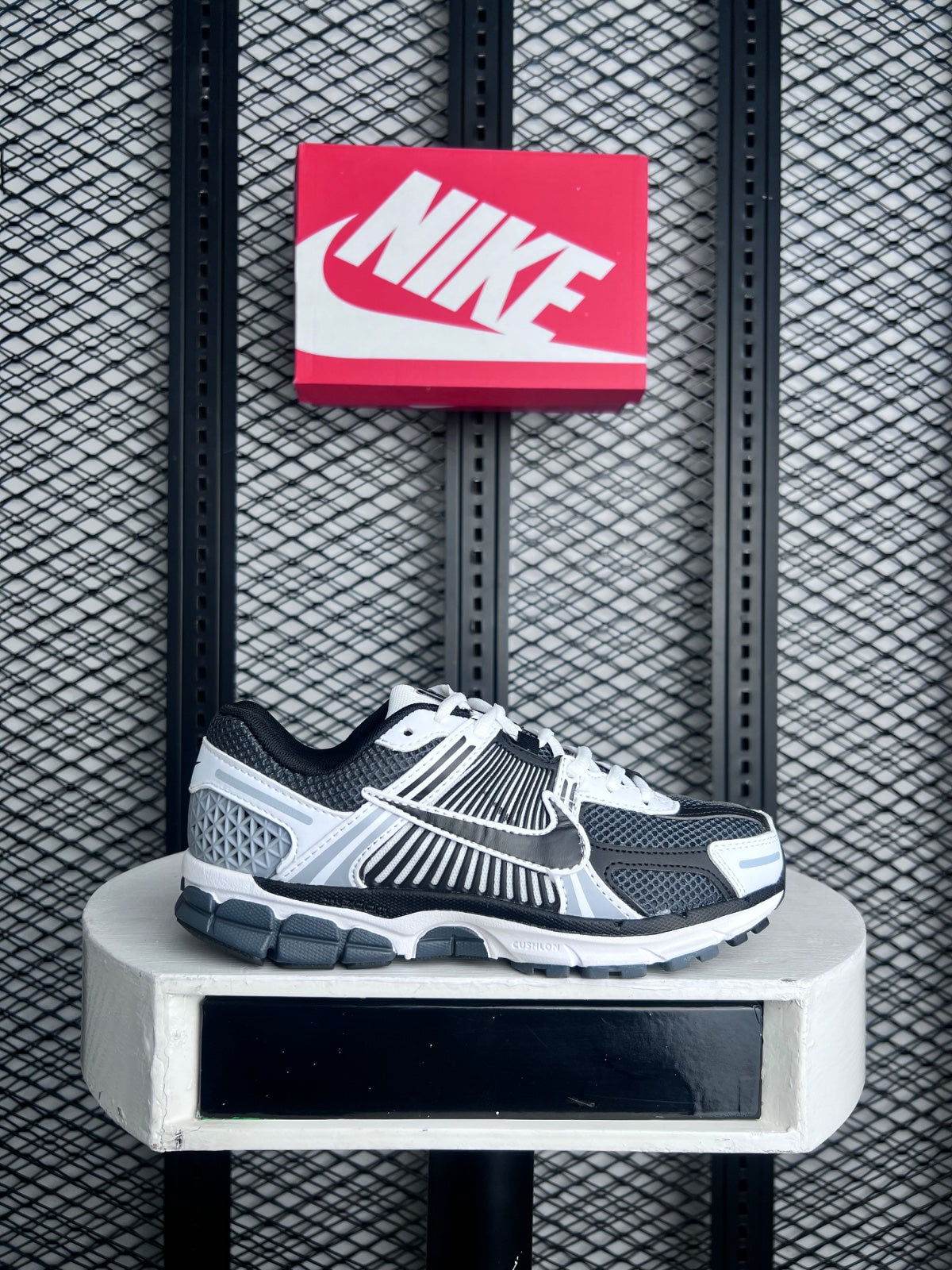 Open-mesh runner with caged overlays in slate and white