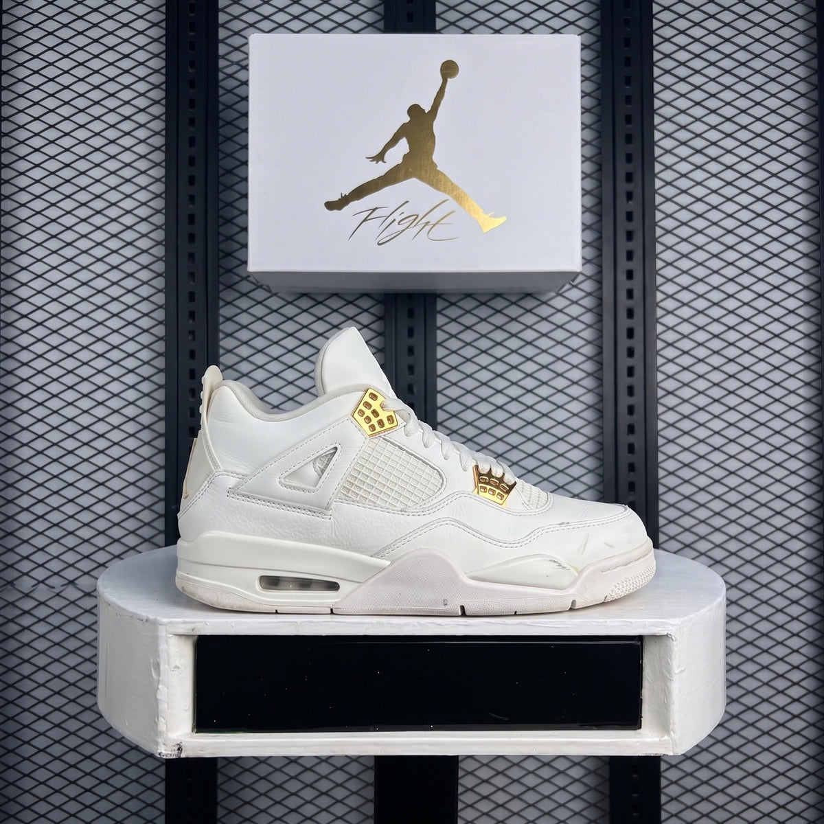 Monochrome white leather mid-top with metallic gold eyelets
