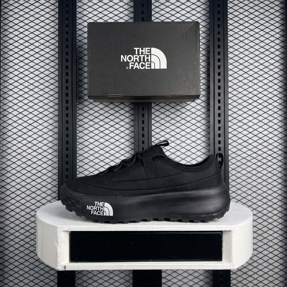 Textured coated low-top in black with outdoor, technical, chunky styling