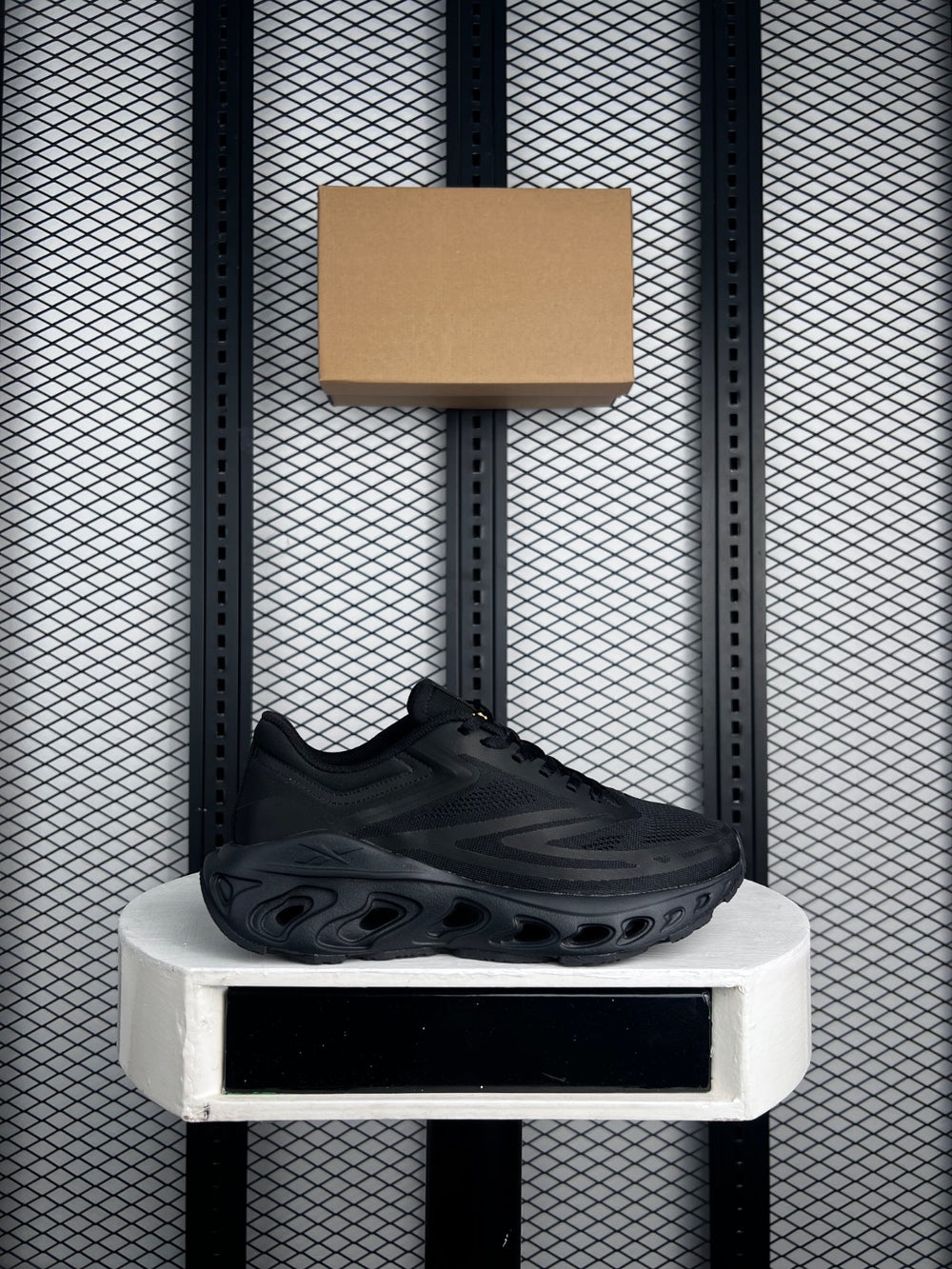 Triple black mesh runner with sculpted cutout midsole