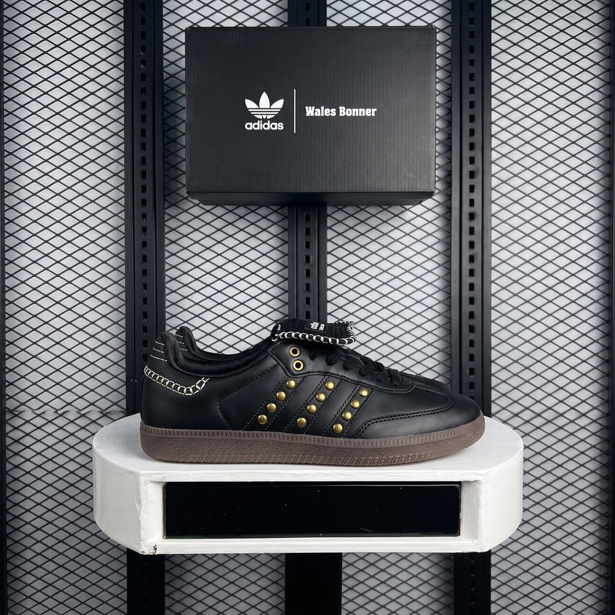Gold-studded low-top trainer with contrast whipstitch detailing