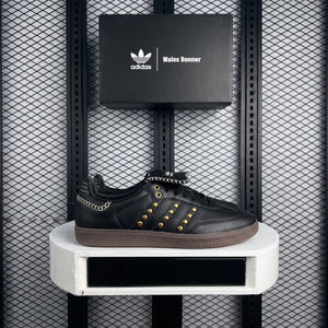 Gold-studded low-top trainer with contrast whipstitch detailing