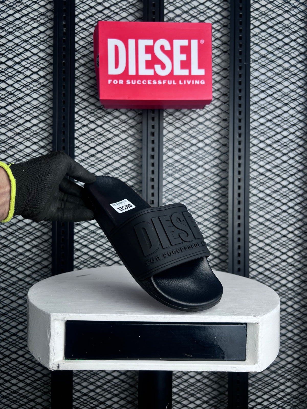 Moulded rubber slide in all-black with embossed strap
