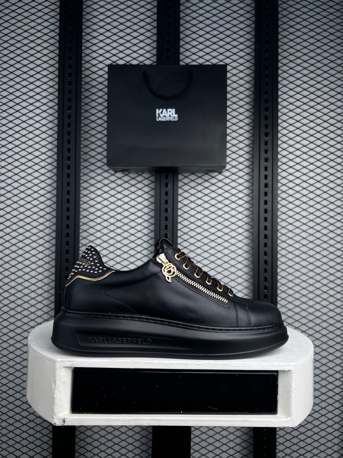 Platform-sole leather sneaker with side zip and studs