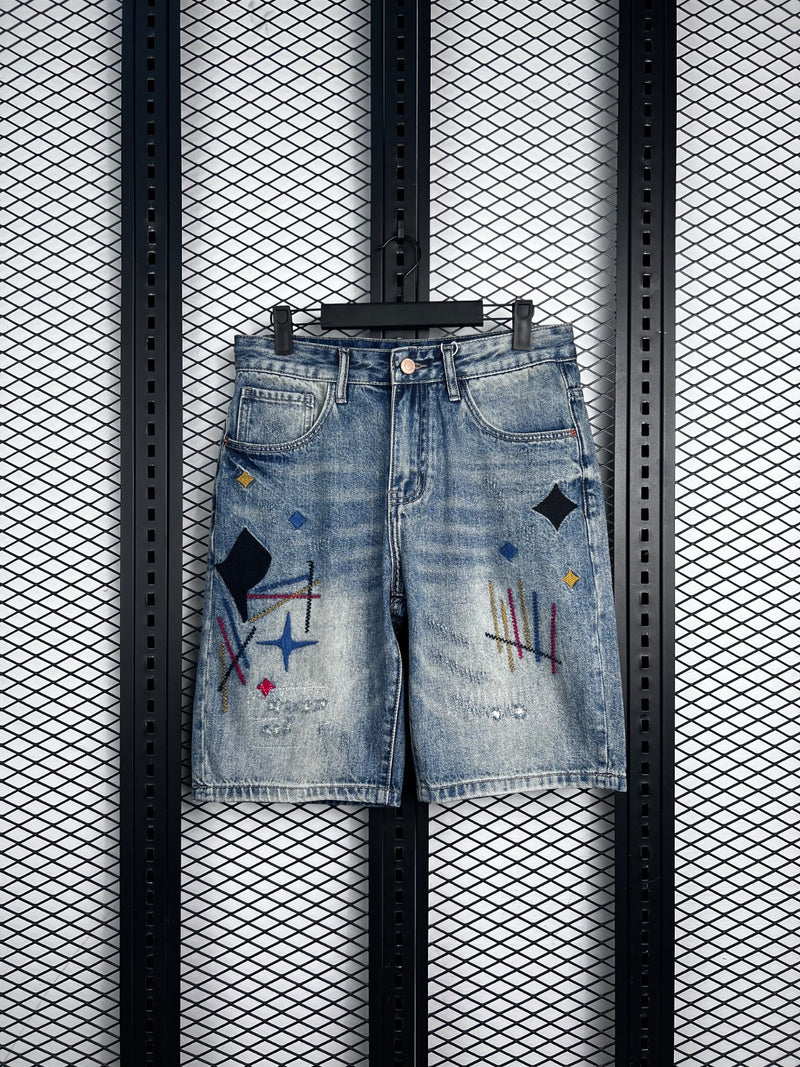 Acid-wash denim shorts with abstract embroidery and patches