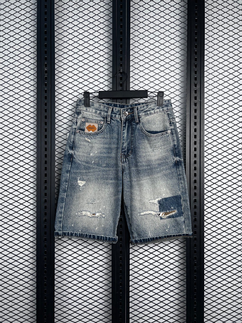 Bermuda cut denim shorts with distressed patch details
