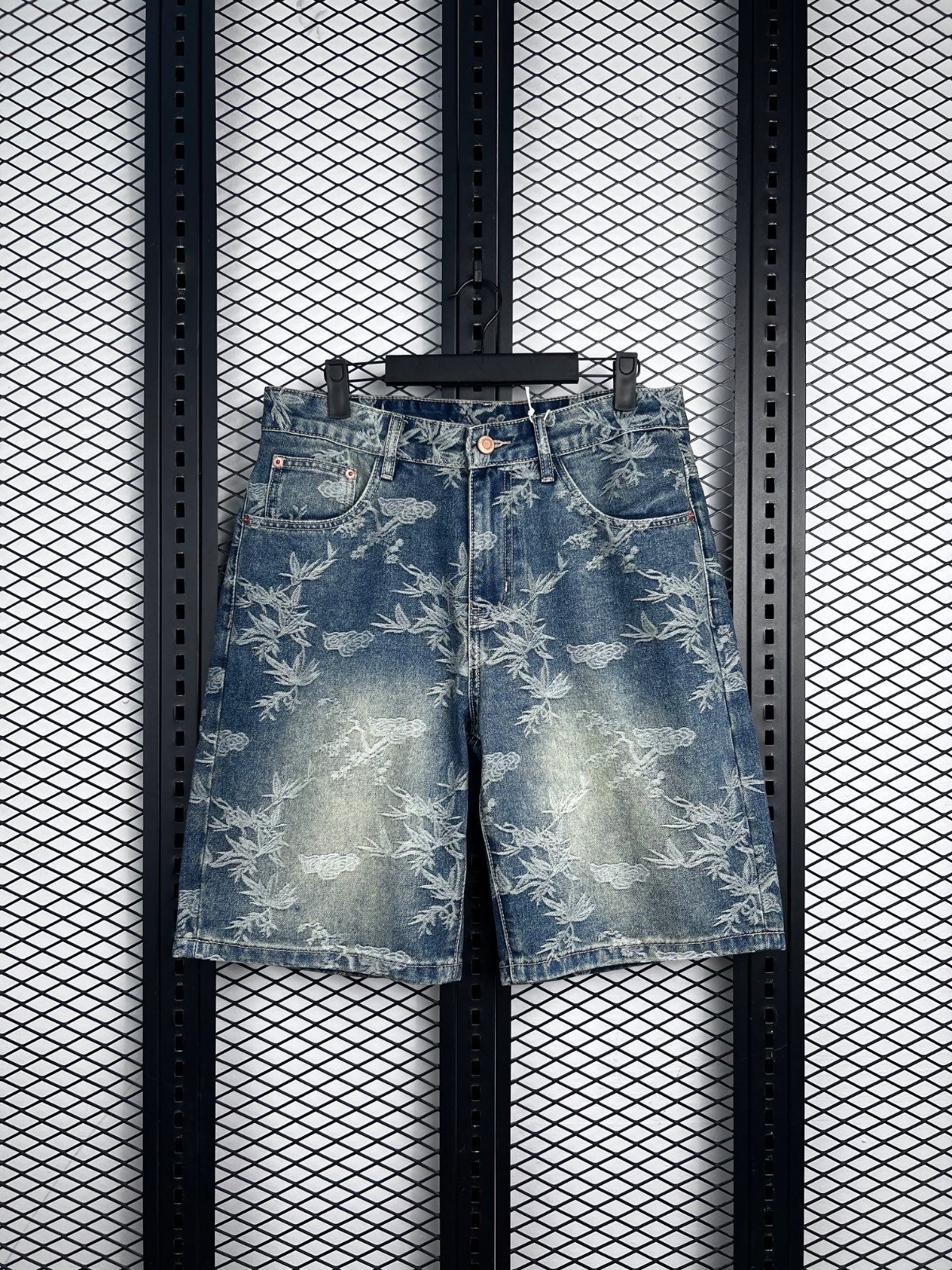 Embroidered foliage pattern denim shorts with copper rivets