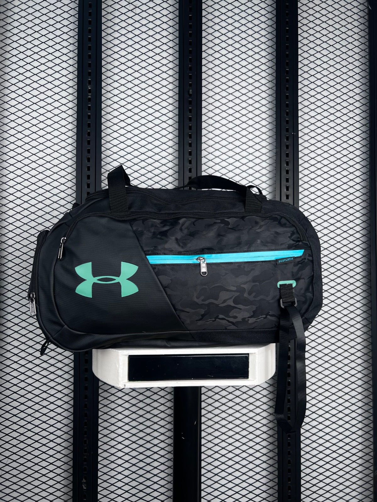 Tonal camo duffle bag with turquoise zip accents