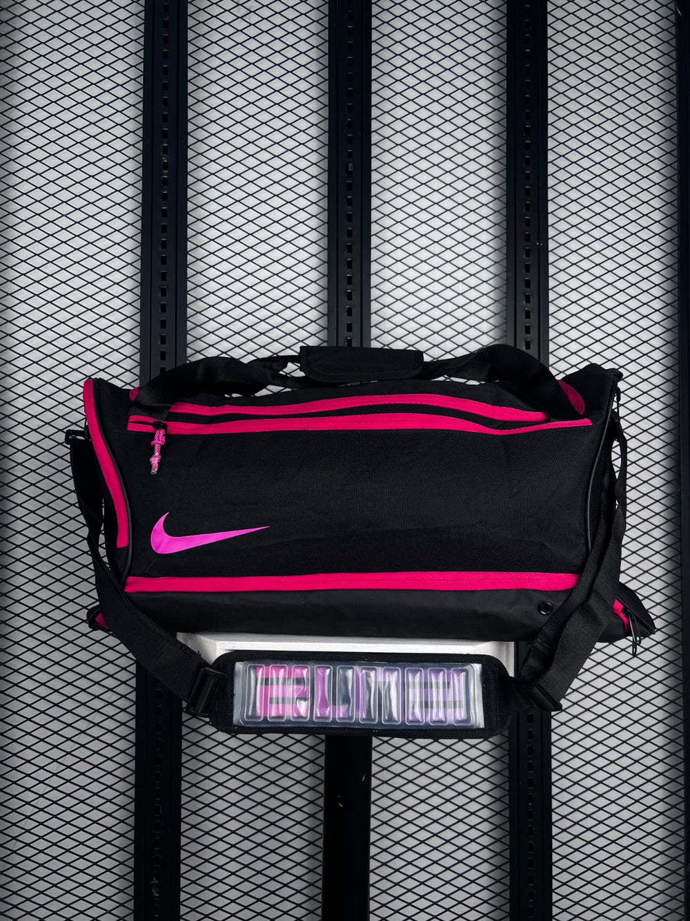 Duffel bag silhouette with bright pink contrast zips