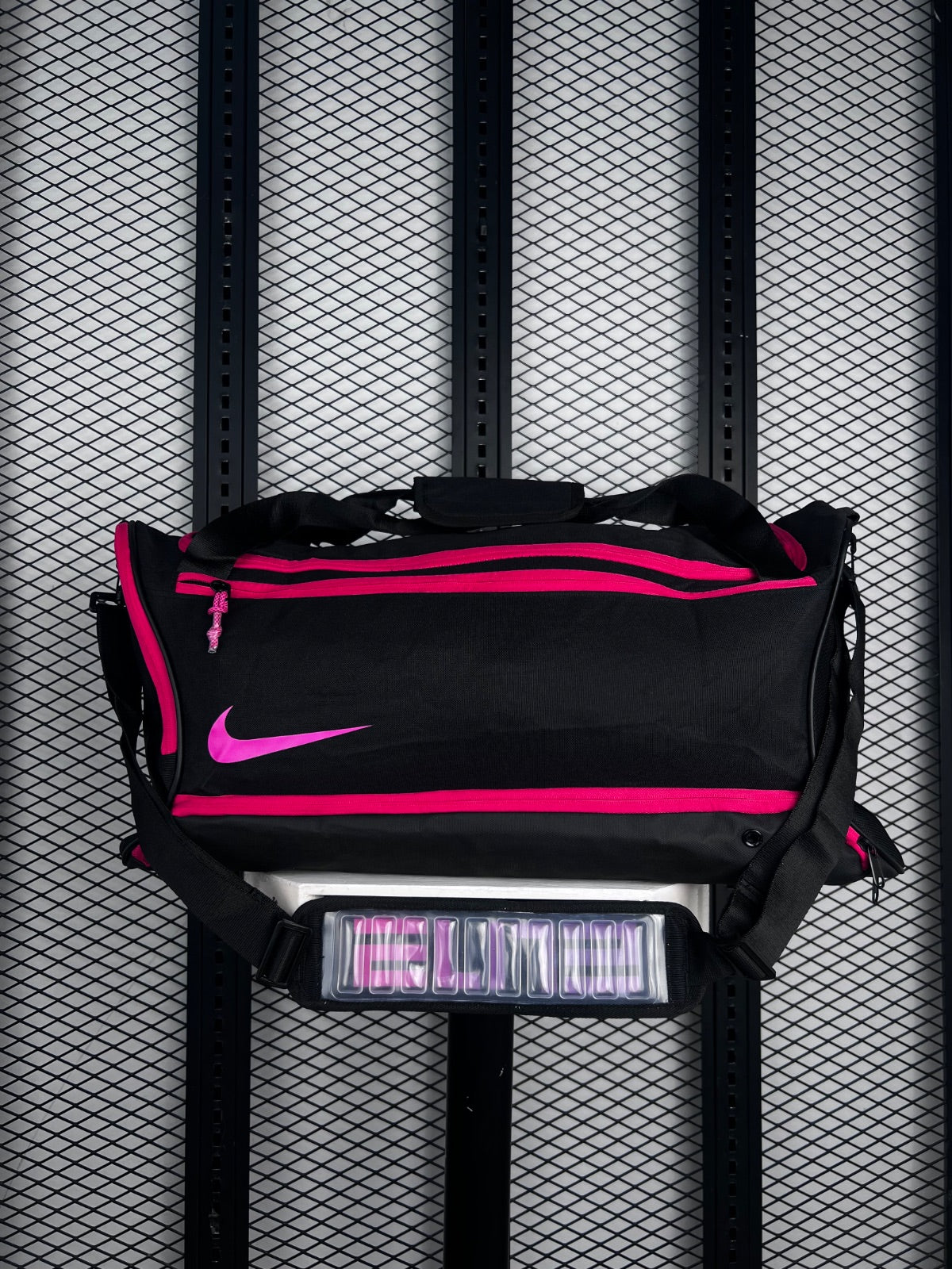 Duffel bag silhouette with bright pink contrast zips
