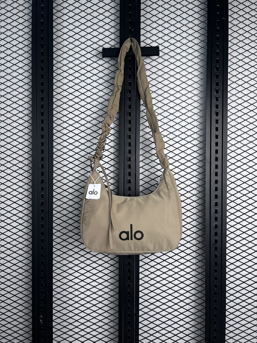 Cream nylon crescent shoulder bag with ruched strap