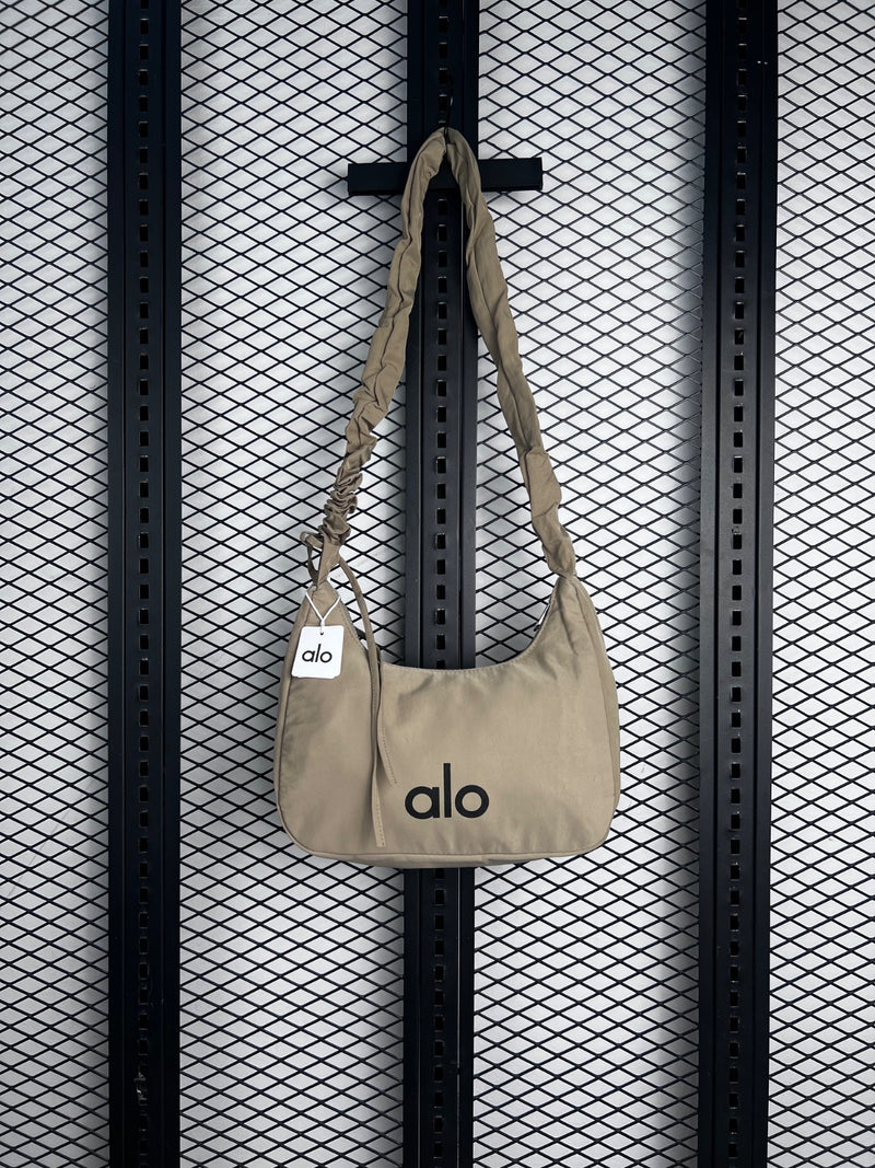 Cream nylon crescent shoulder bag with ruched strap