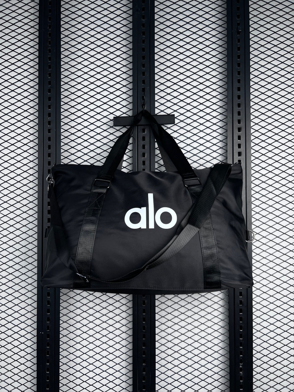 Black nylon duffle tote with webbing straps