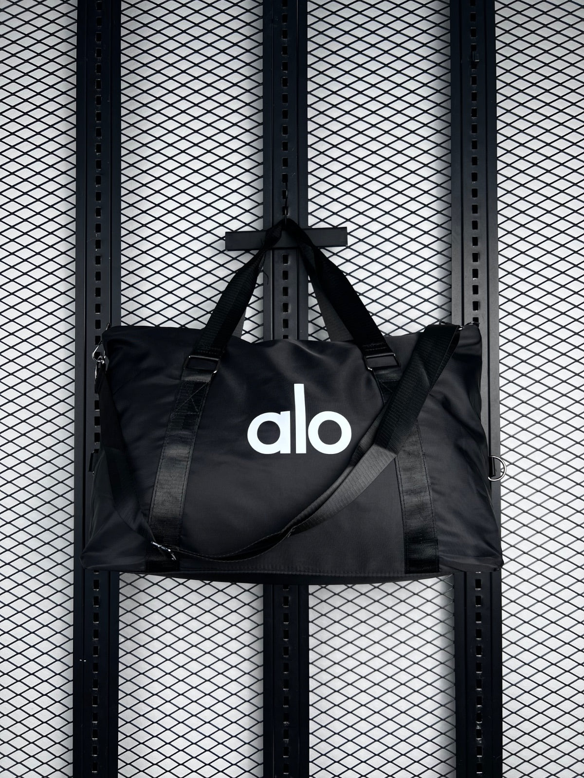 Black nylon duffle tote with webbing straps