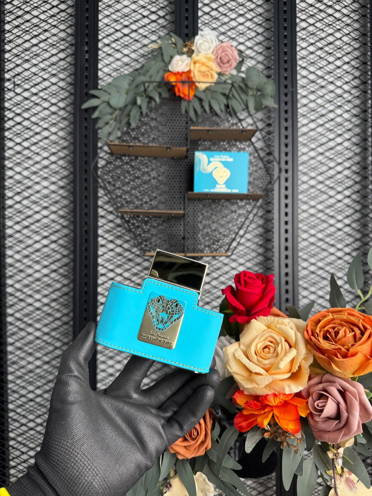 Embossed turquoise fragrance box with metallic snake motif