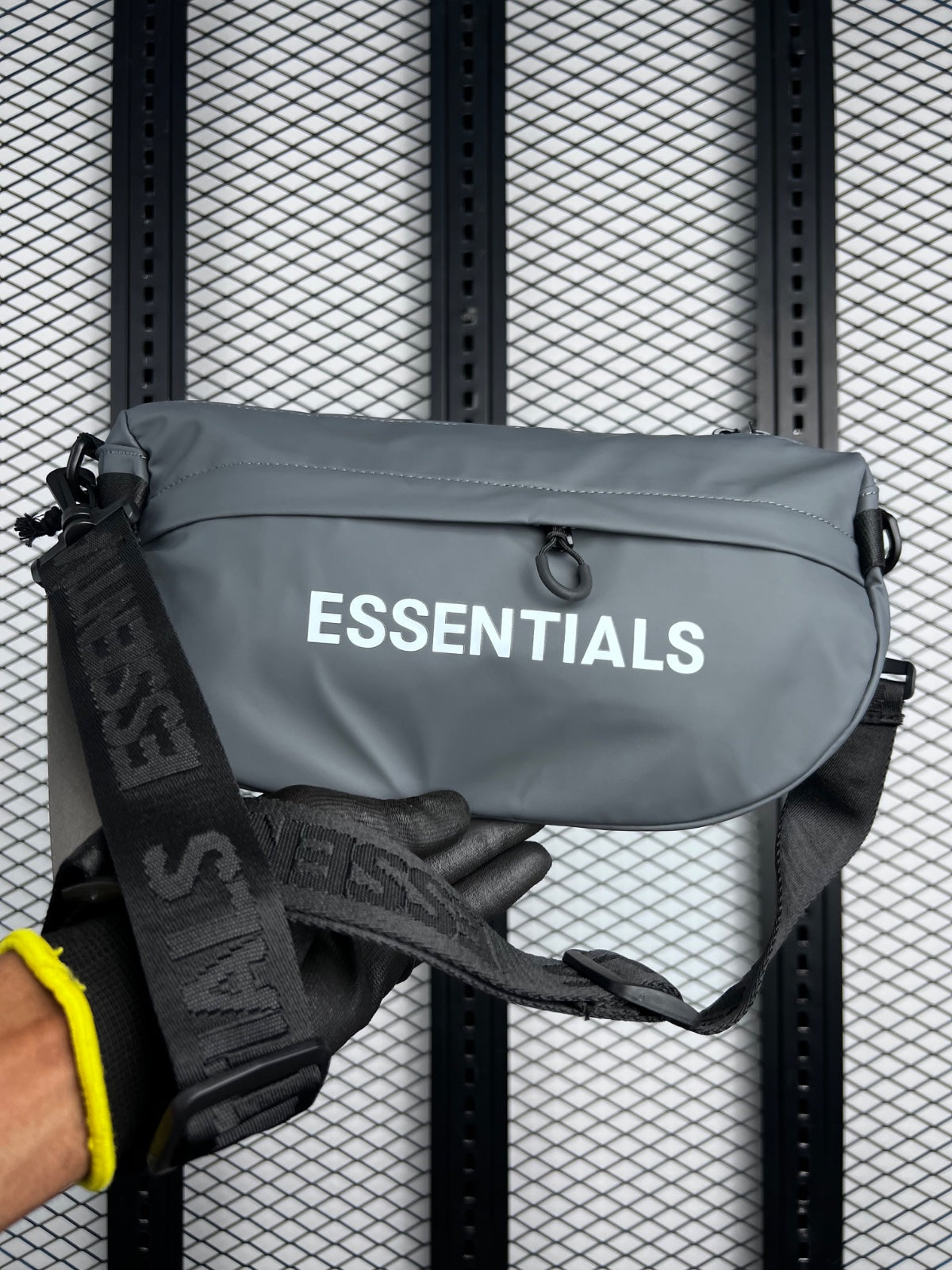 Matte-coated grey crossbody pouch with branded strap