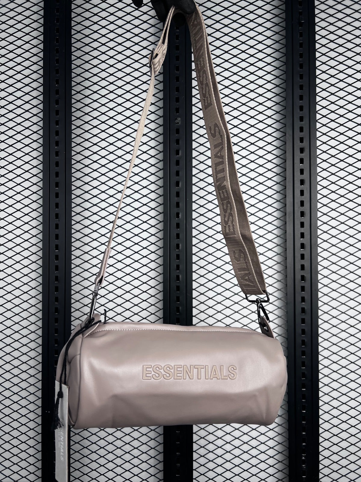 Embossed lettering cylindrical shoulder bag in matte taupe