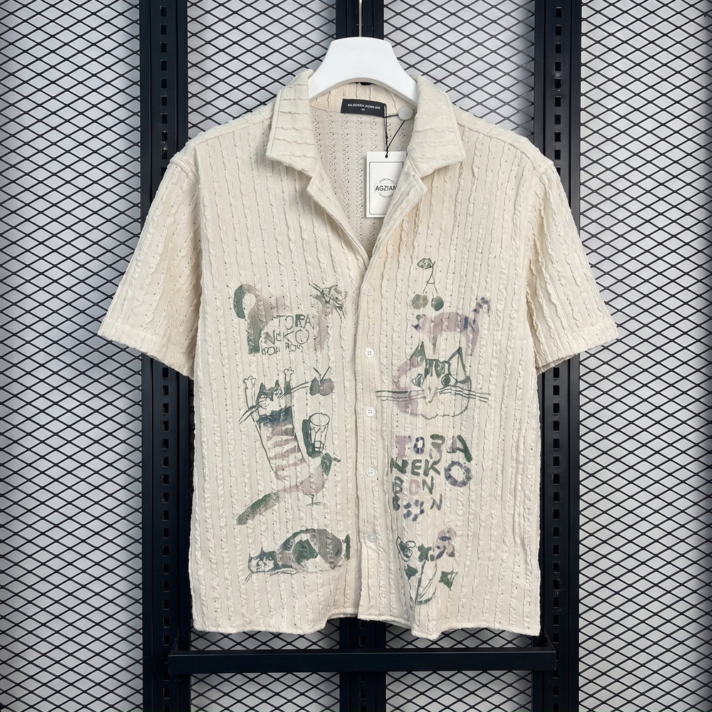 Short-sleeve camp-collar shirt in textured cream with cat sketches