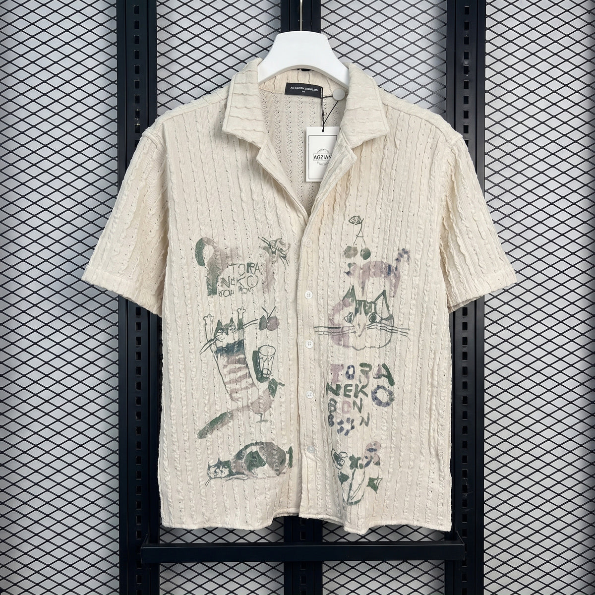 Short-sleeve camp-collar shirt in textured cream with cat sketches