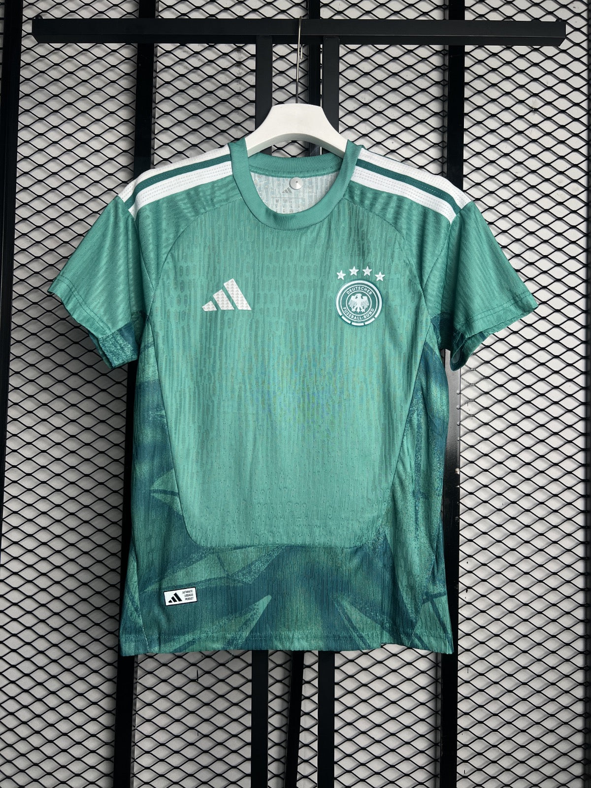 Smooth technical green athletic jersey with white shoulder stripes