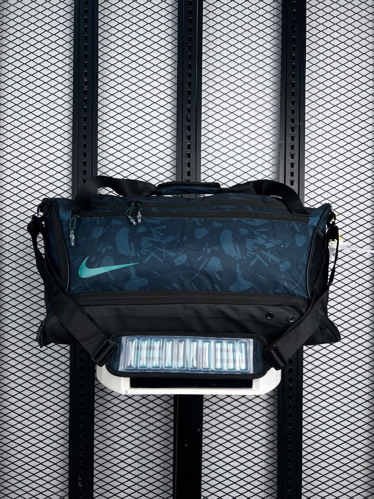 Zip-compartment printed canvas duffel with teal accents