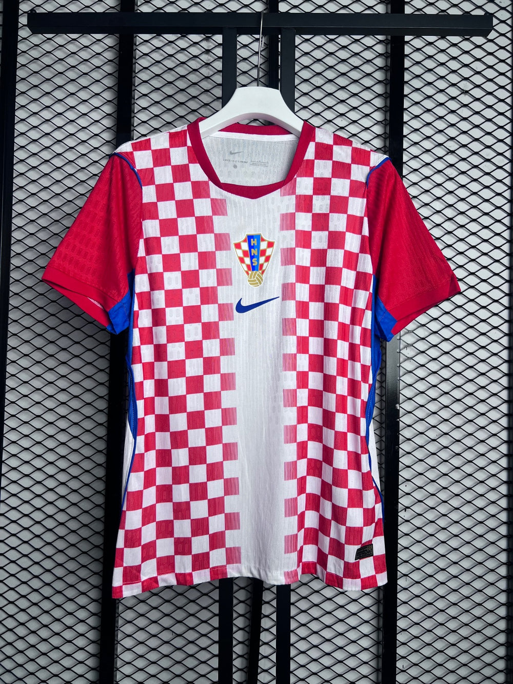 Red and white checkered football jersey with blue trim
