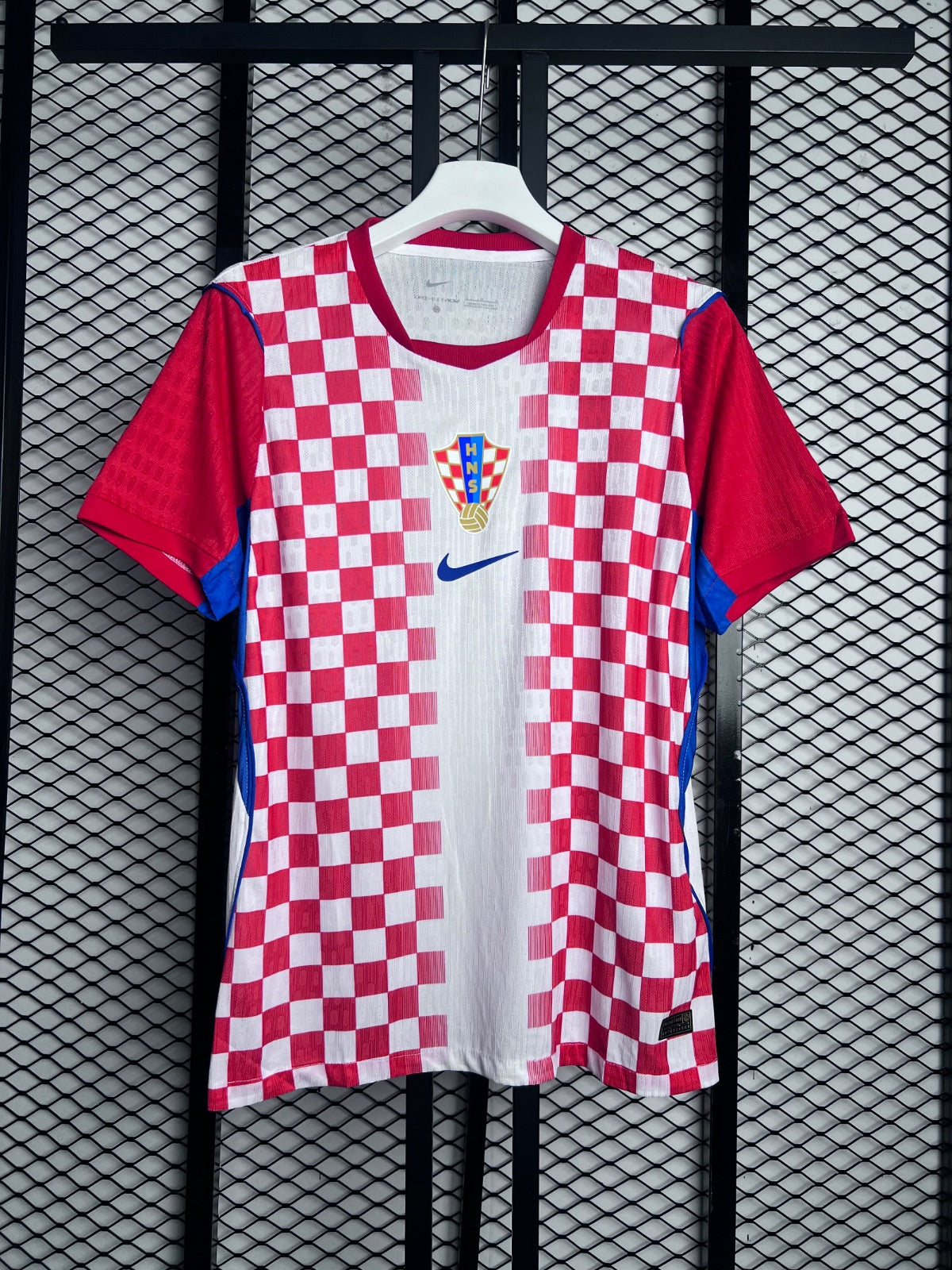 Red and white checkered football jersey with blue trim