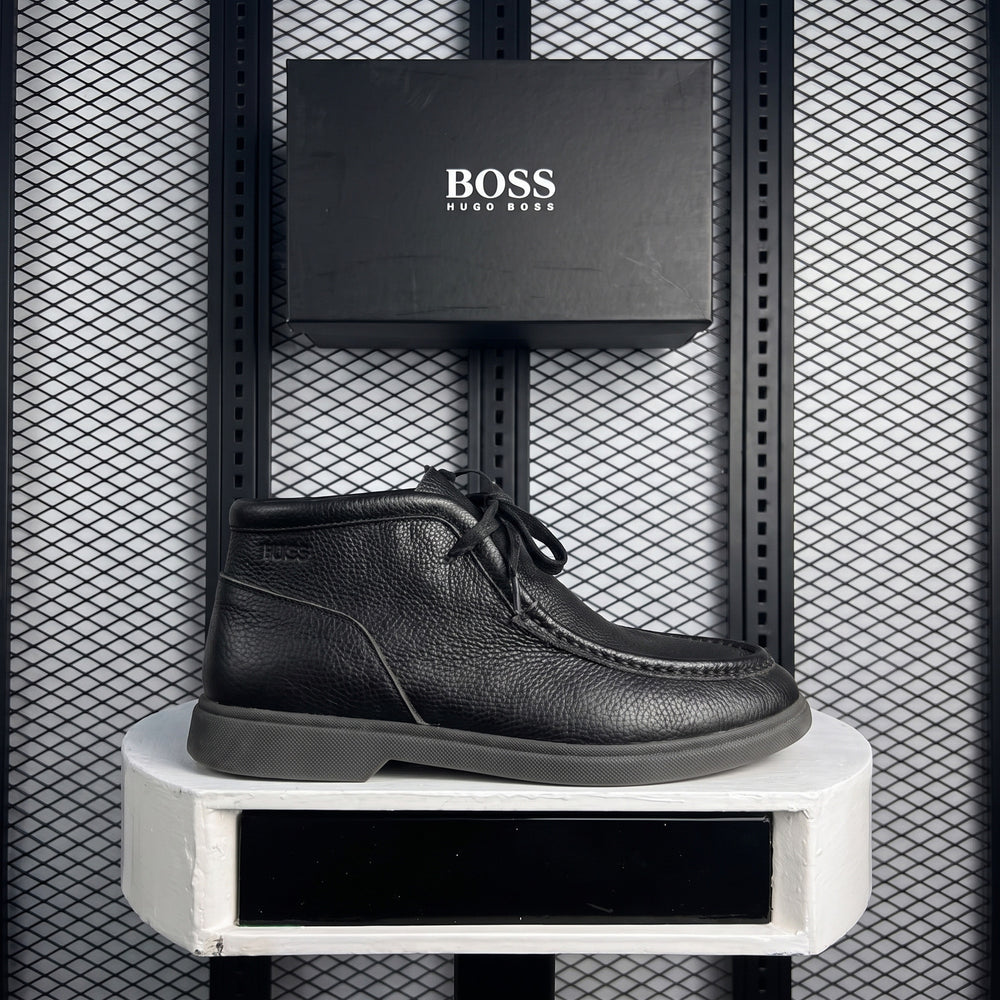 Moc-stitched pebbled leather ankle boot in black