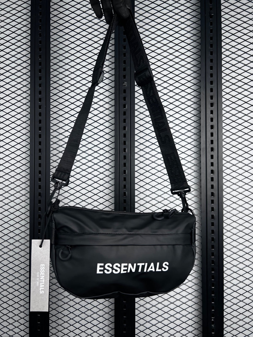 Curved semi-oval sling bag in coated black