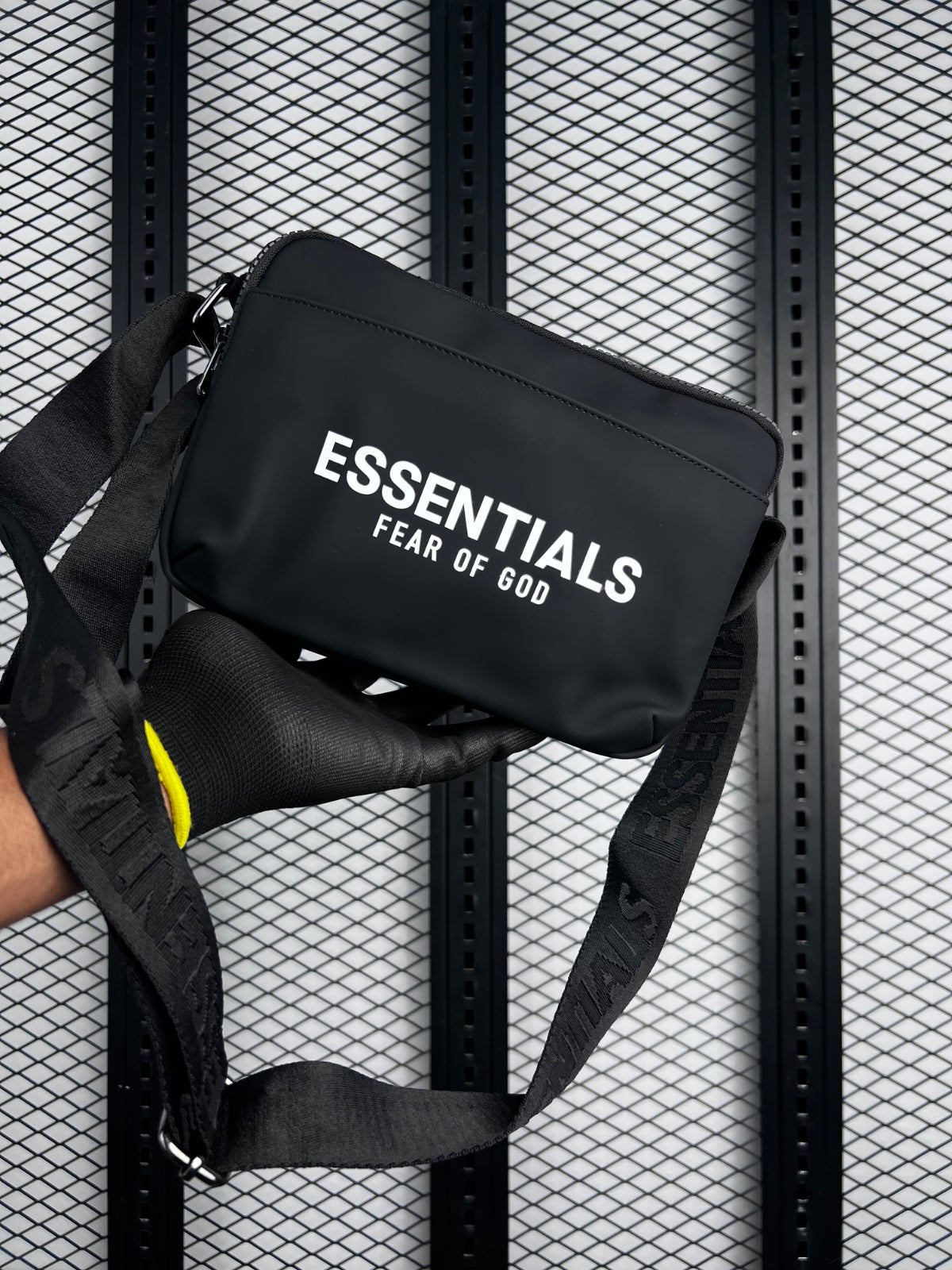 Matte black rectangular crossbody bag with printed typography