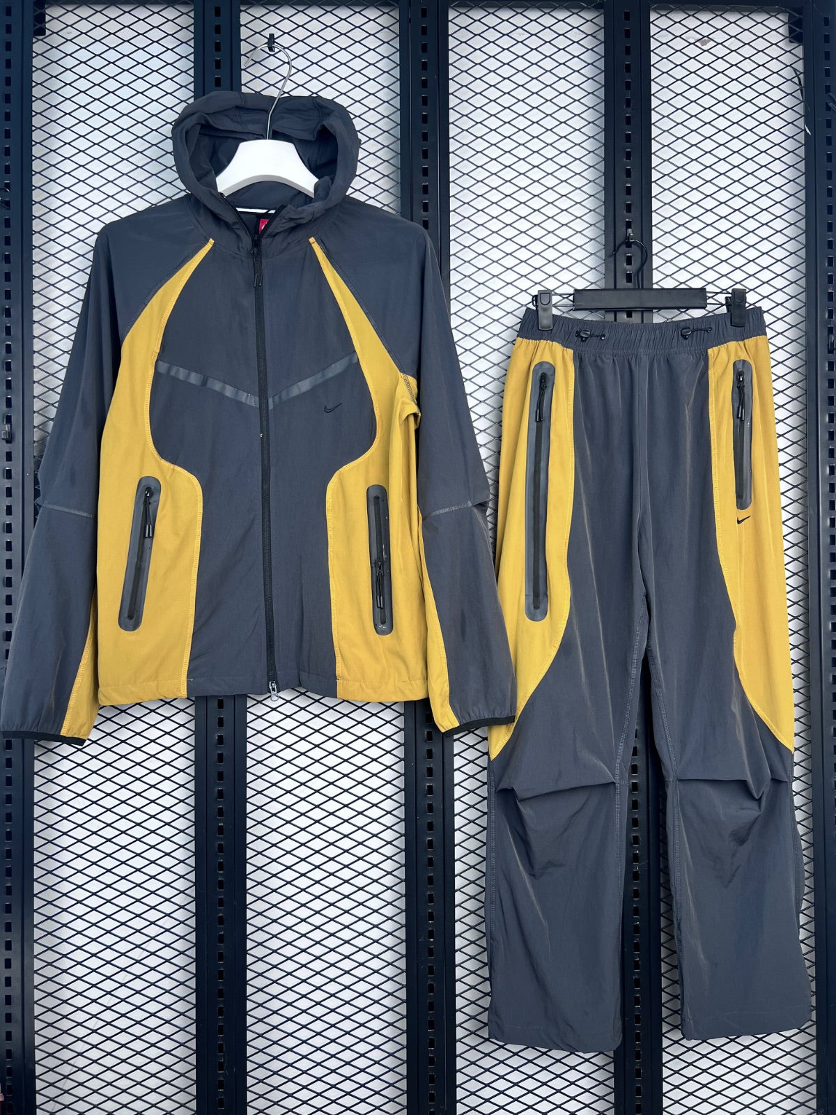 Two-piece hooded tracksuit silhouette in charcoal and mustard