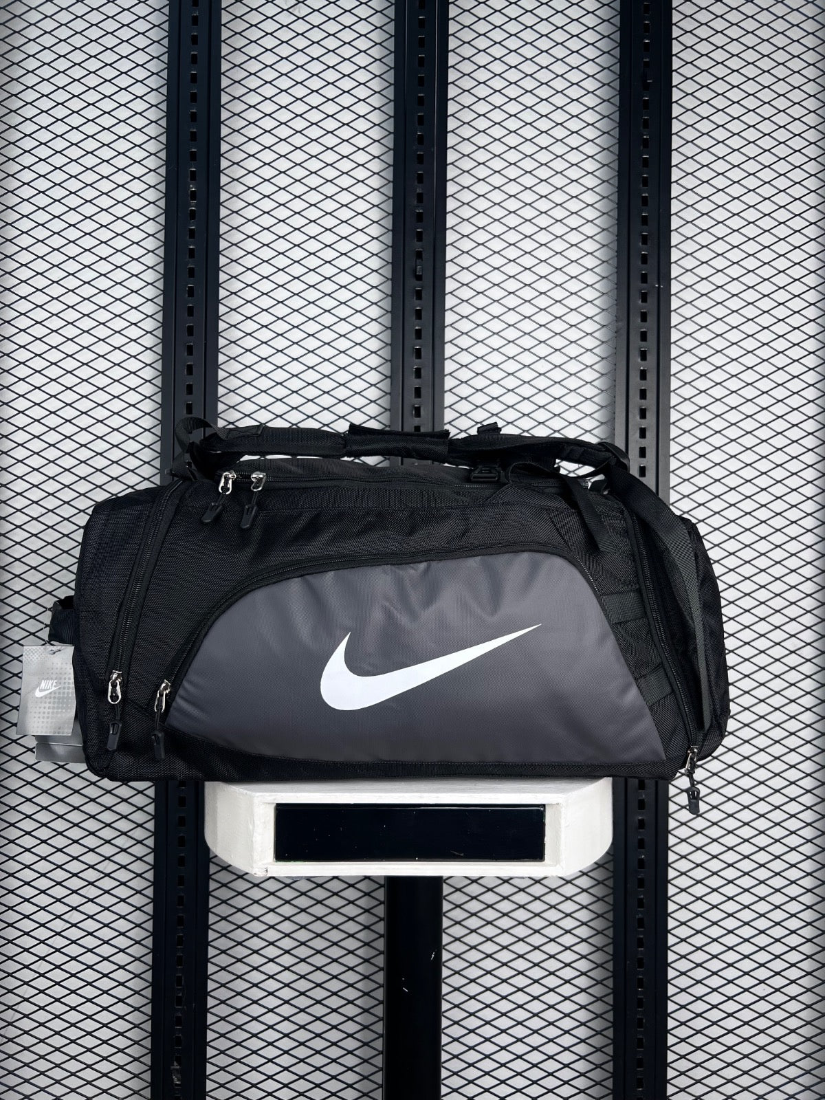 Black and charcoal two-tone duffel bag with front zip