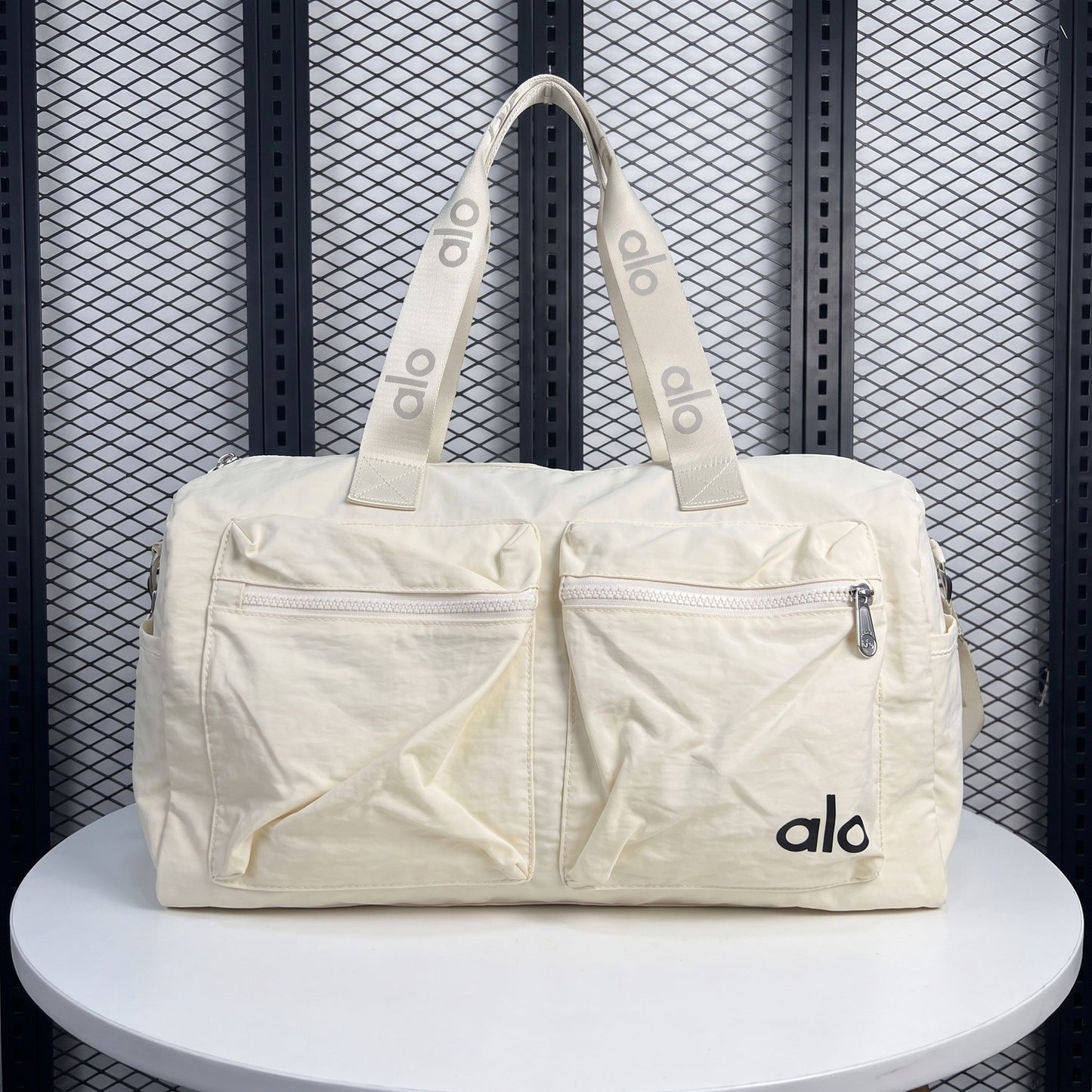 Dual front-pocket nylon duffle bag in cream