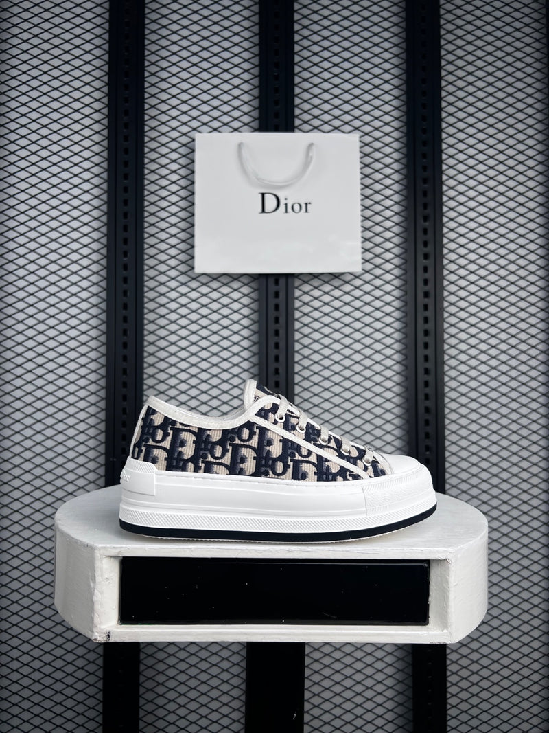Platform low-top silhouette with navy monogram embroidery