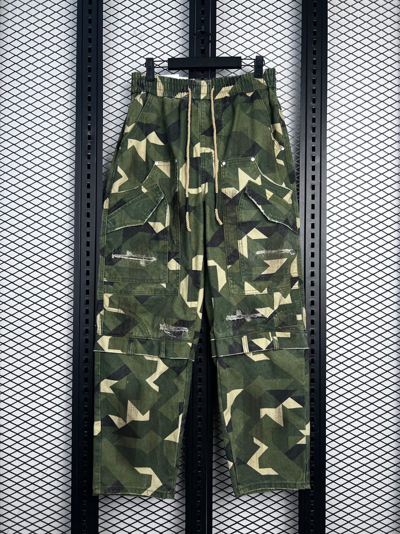 Drawstring-waist geometric camo cargo pants with distressed patches