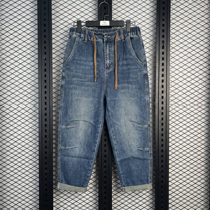 Drawstring elastic-waist tapered denim joggers with pleats