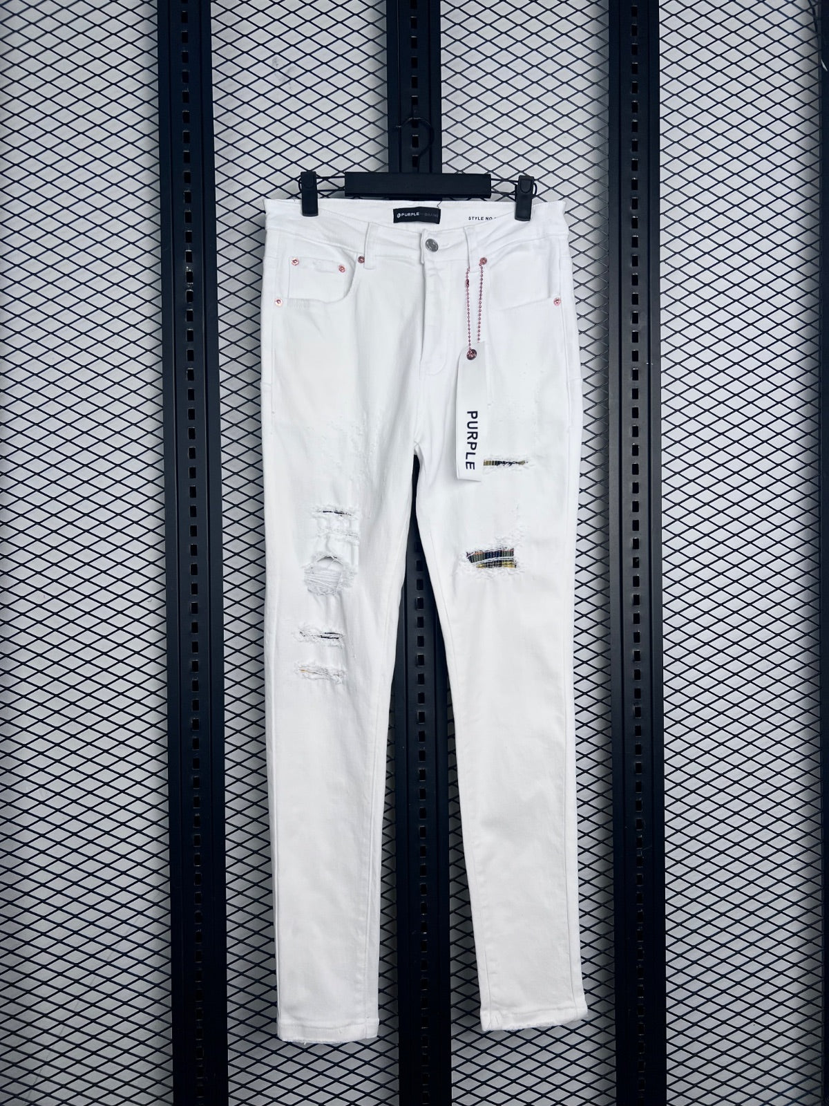 White slim jeans with distressed plaid patch accents