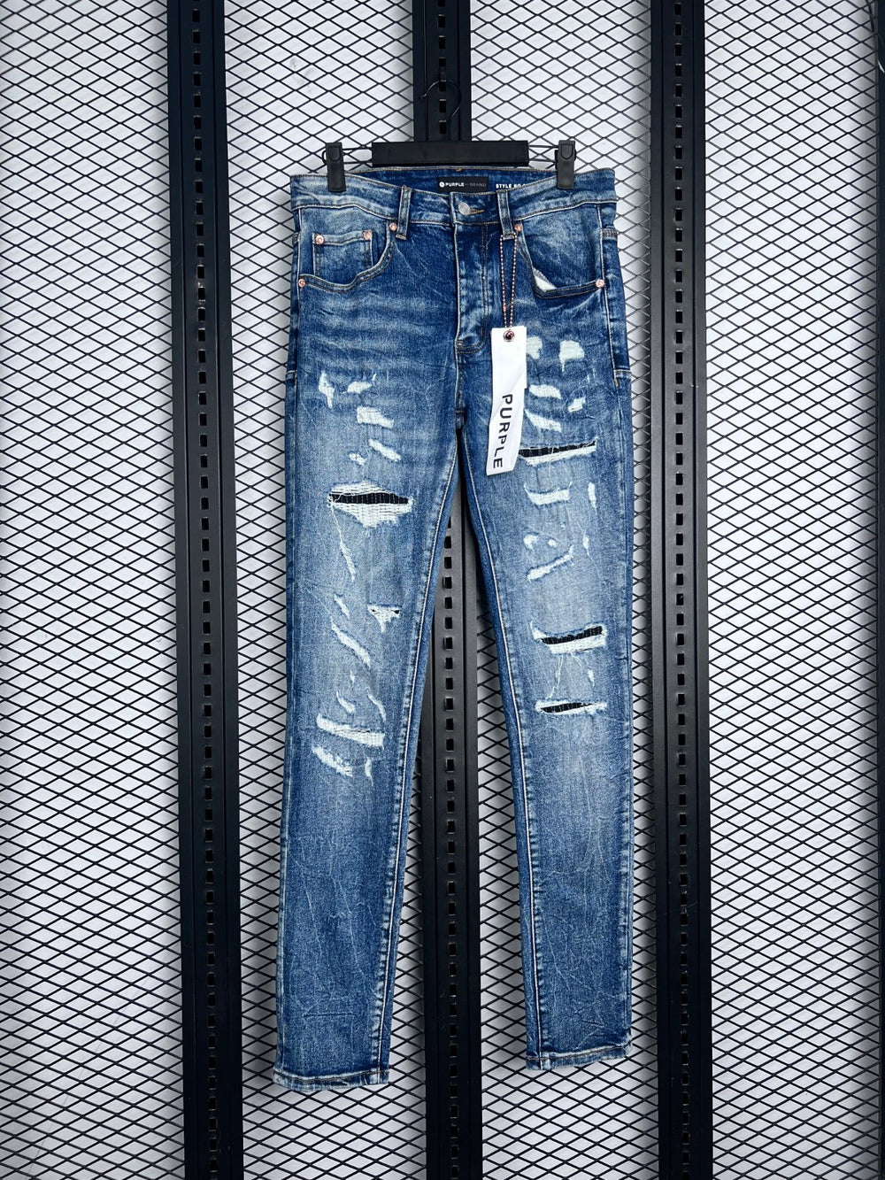 Distressed and ripped slim denim in washed blue