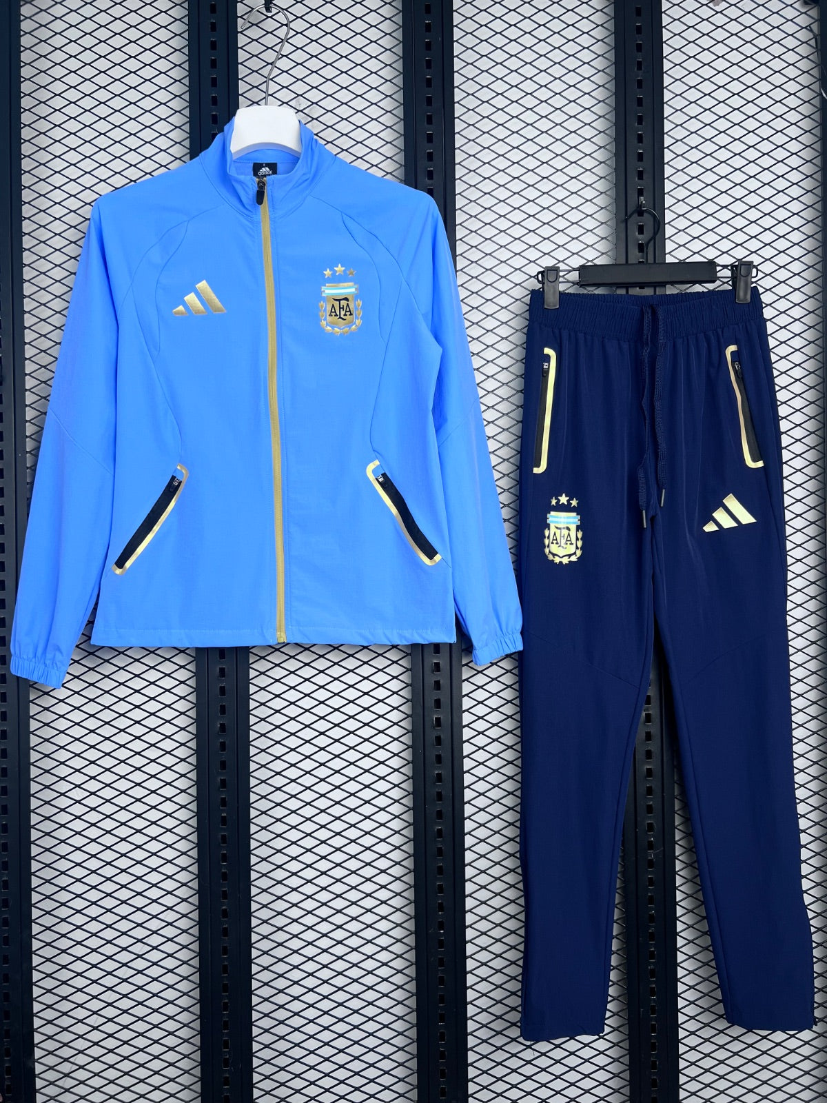 Zip-up track silhouette in sky blue with gold trim