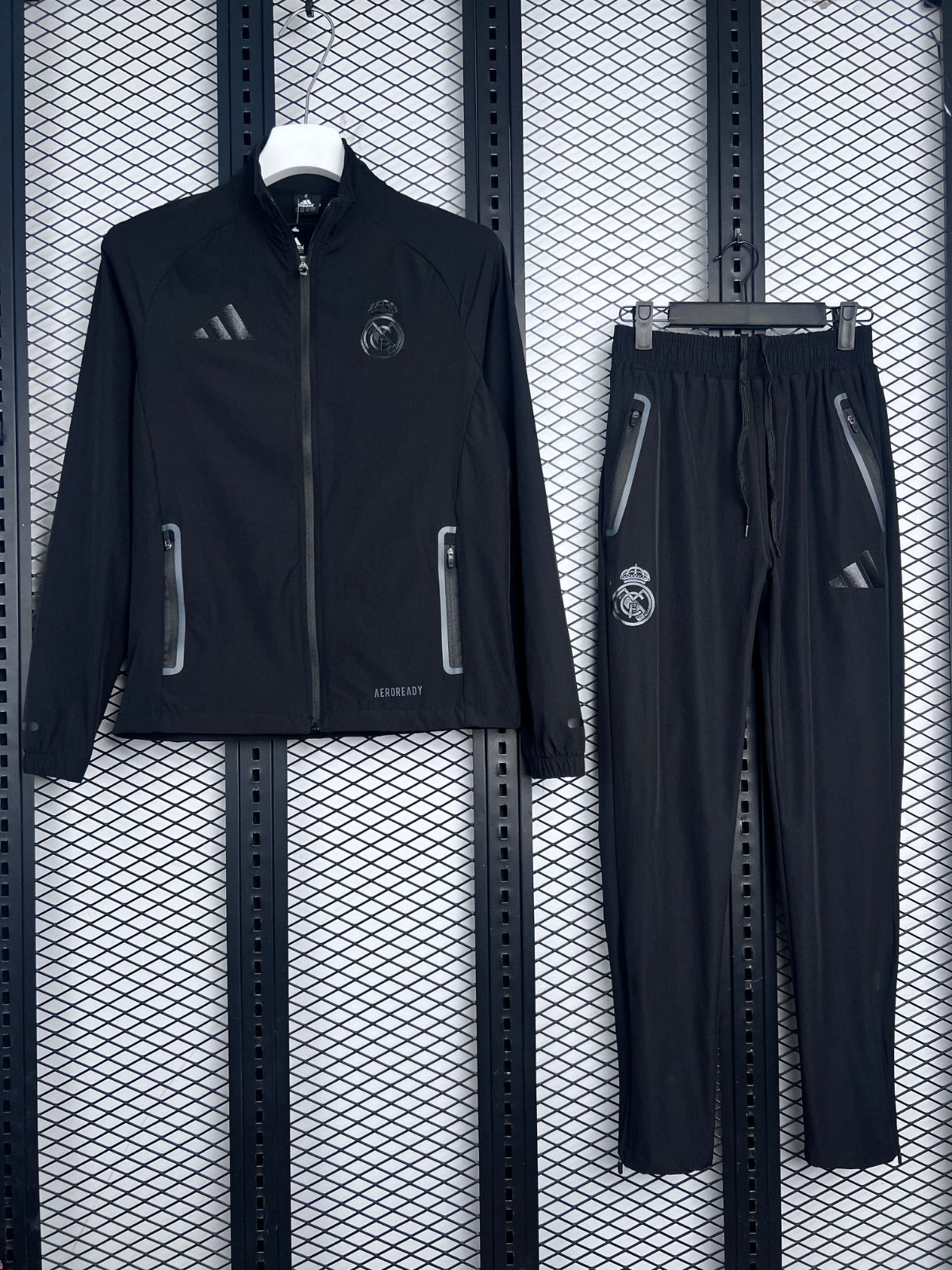 Black zip-front athletic jacket with tonal chest prints