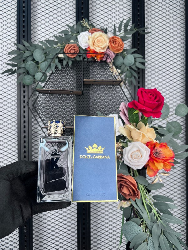 Crown-topped glass perfume bottle with blue