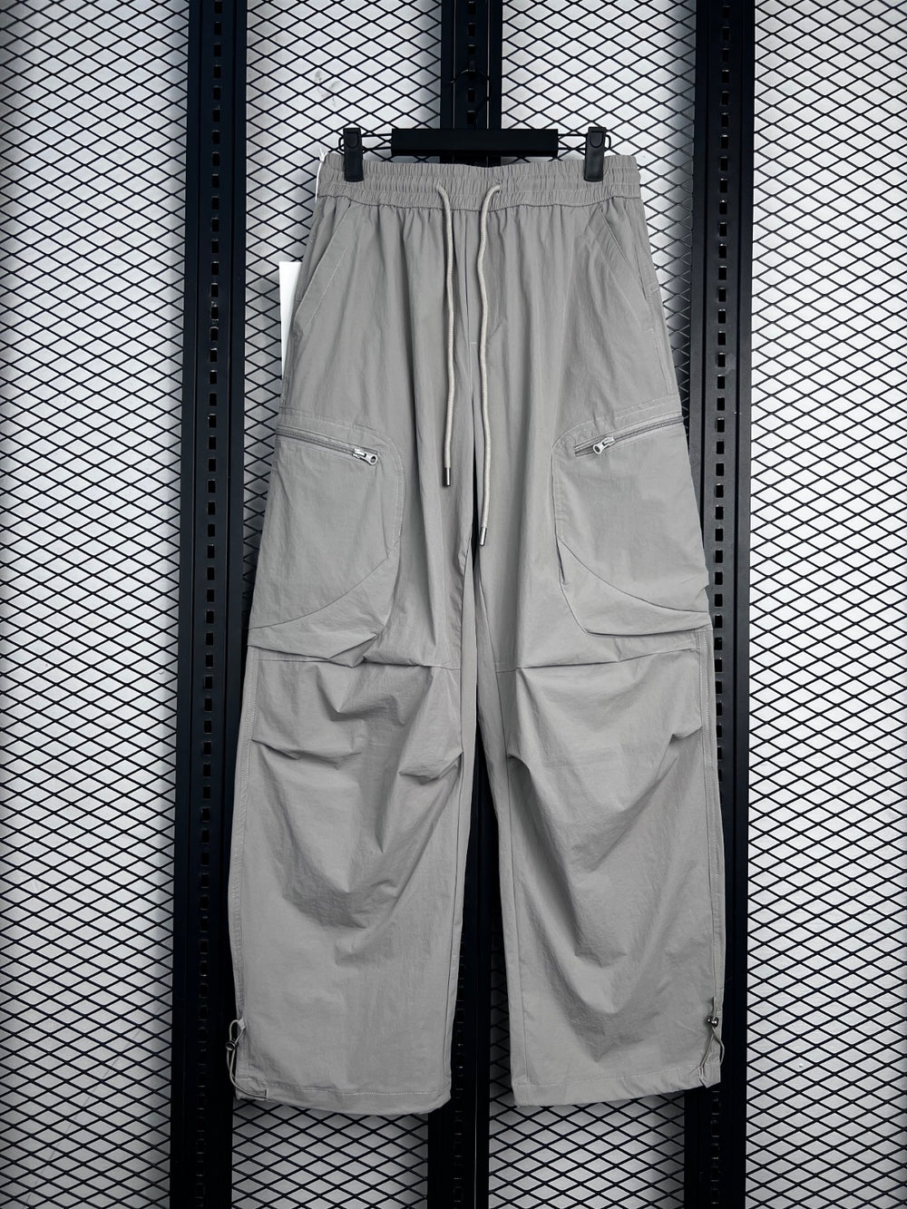 Drawstring-waist nylon parachute trousers with zip pockets
