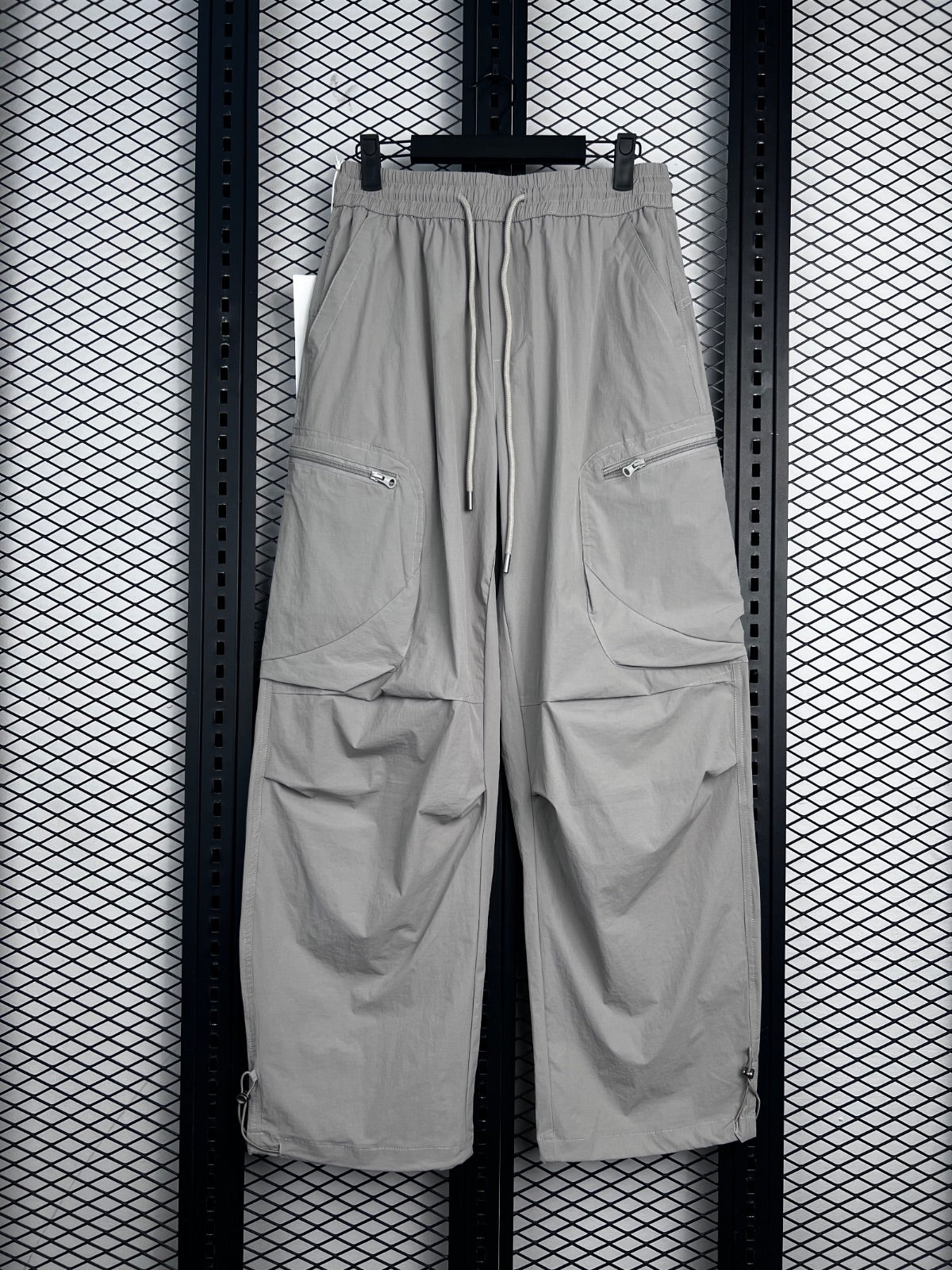 Drawstring-waist nylon parachute trousers with zip pockets