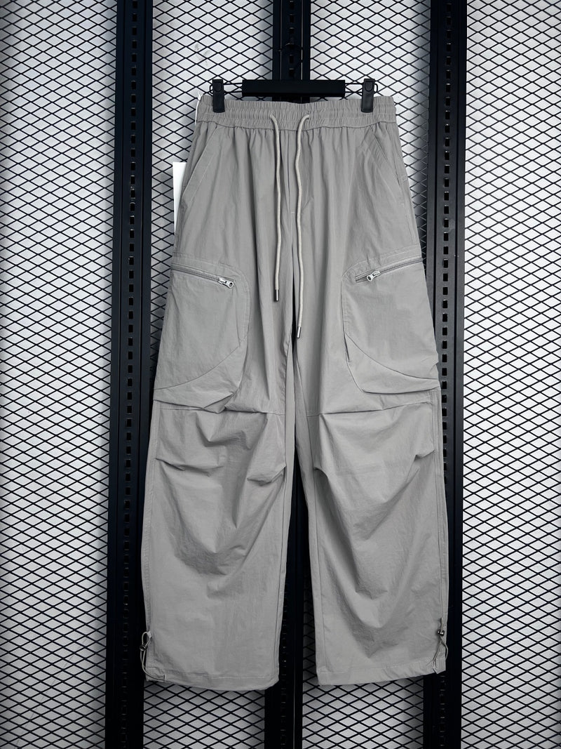 Drawstring-waist nylon parachute trousers with zip pockets