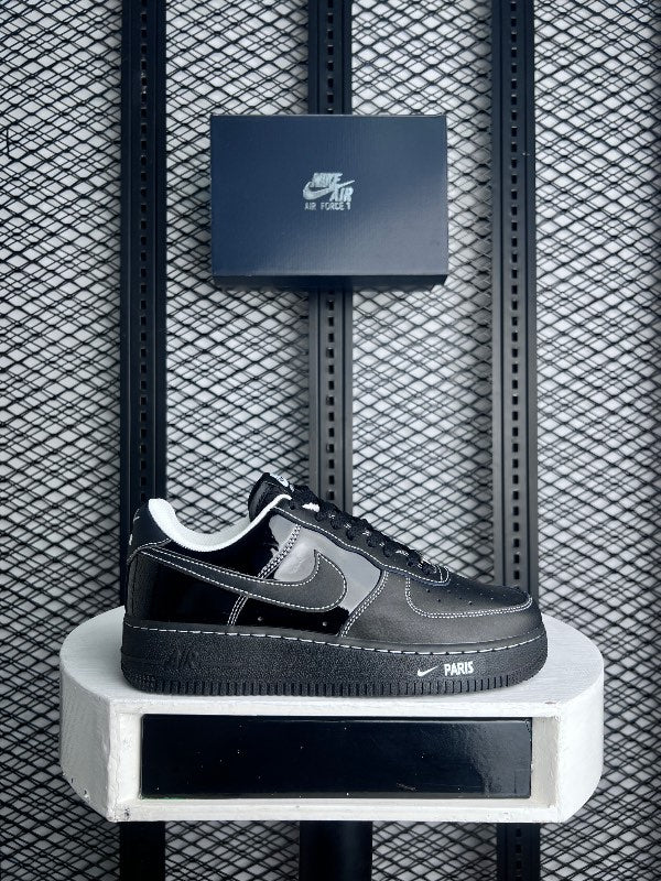 Contrast-stitched black patent and matte leather trainer