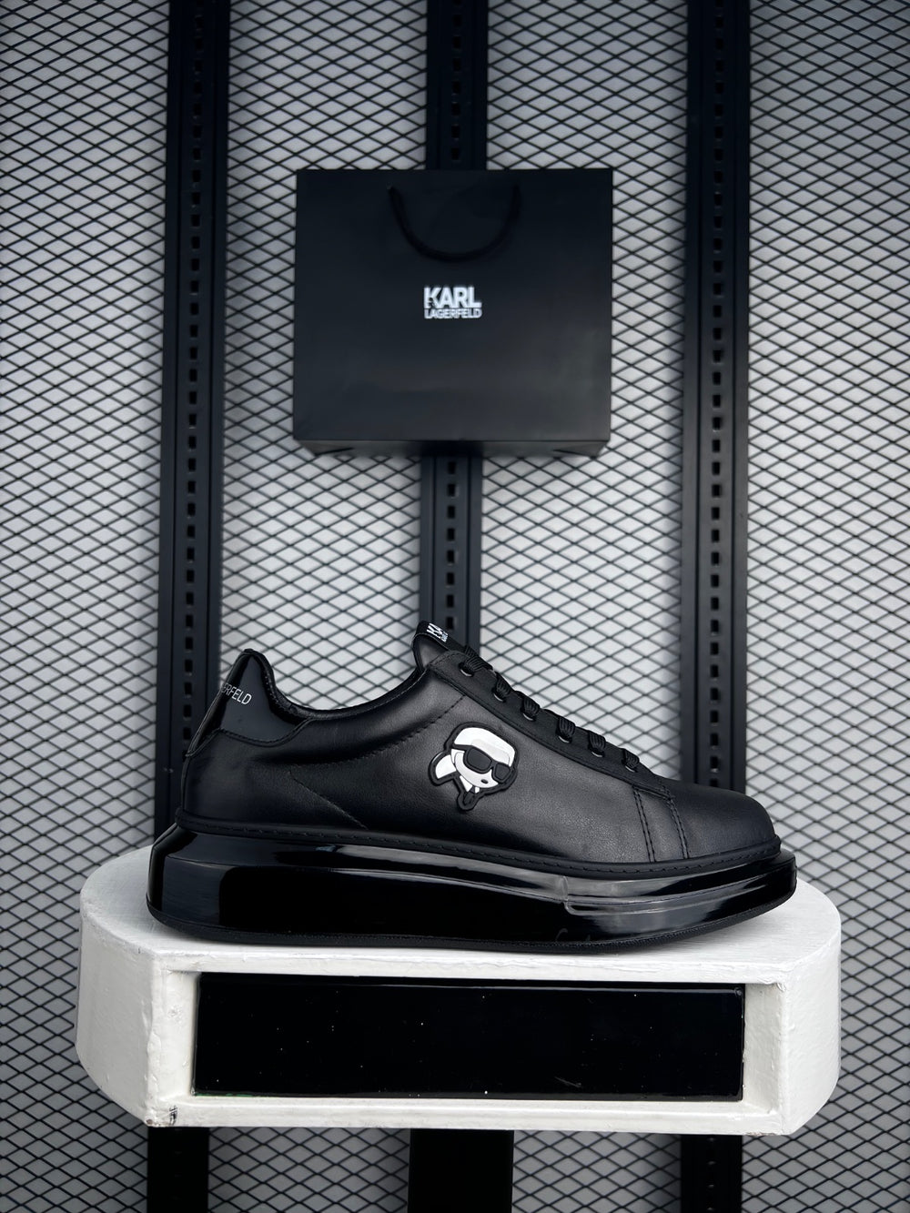 Black leather platform low-top with side figure patch